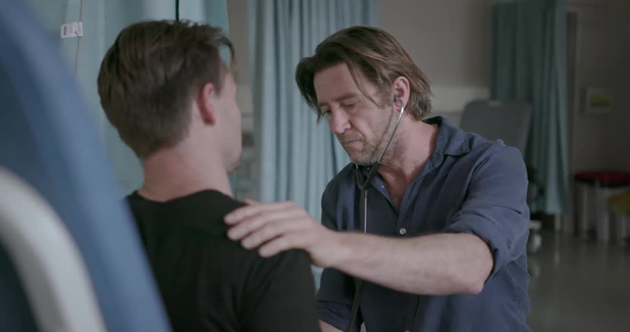 A doctor uses a stethoscope on a patient