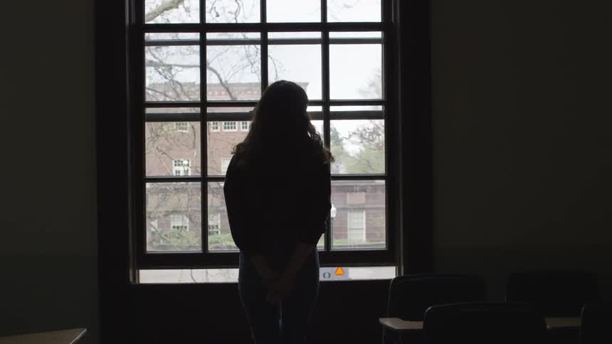 Woman looking through a window