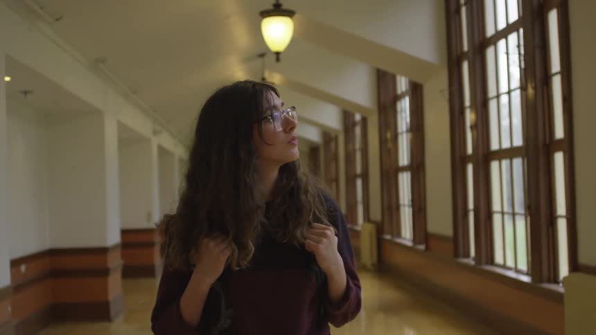 Woman walking down a hallway