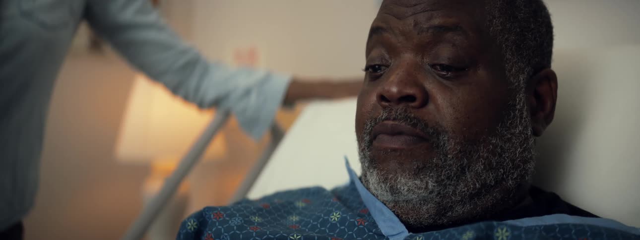Man sits up in hospital bed