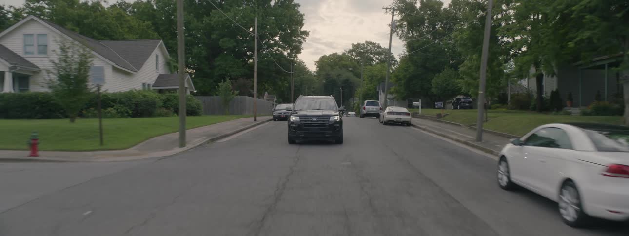 Car drives down road towards camera
