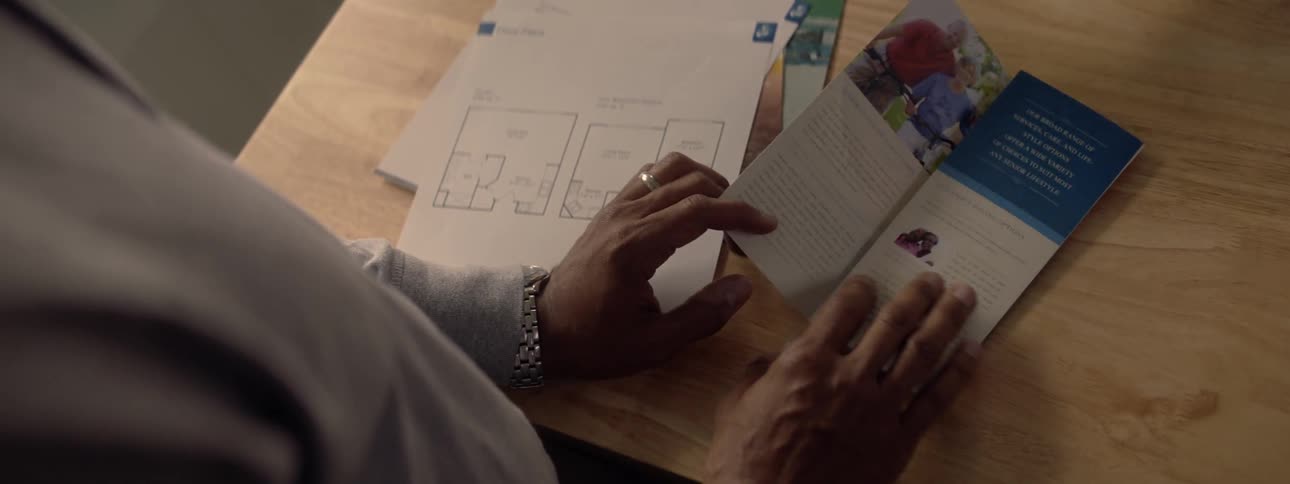 Person at table opens up brochure