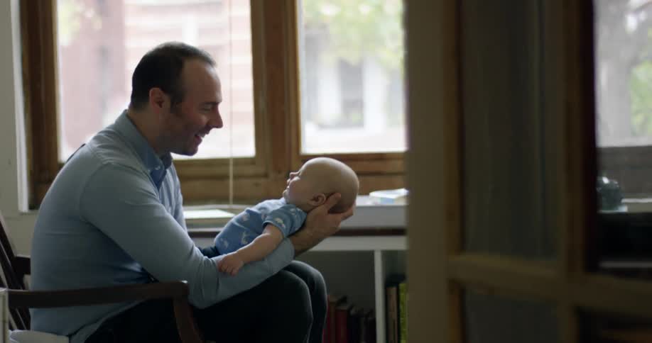 A man holding a baby in his arms
