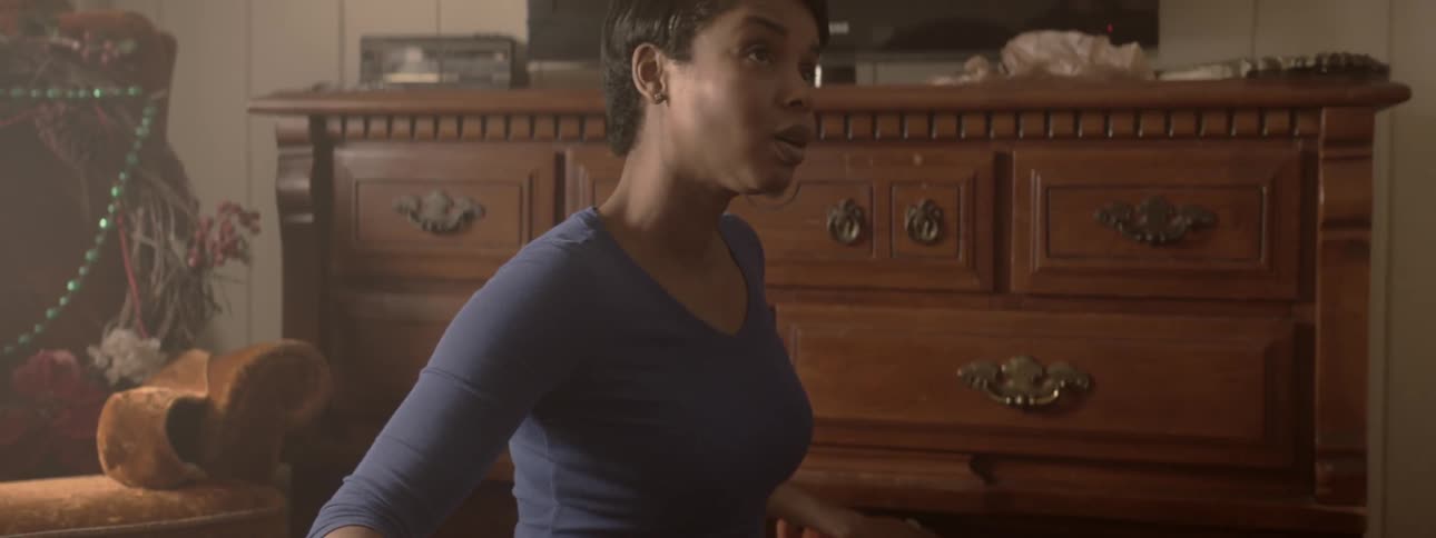Woman looks up as she puts something in drawer