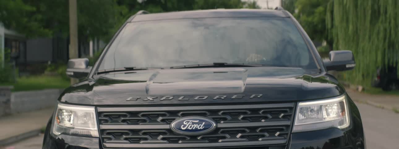 Ford explorer drives down suburban street