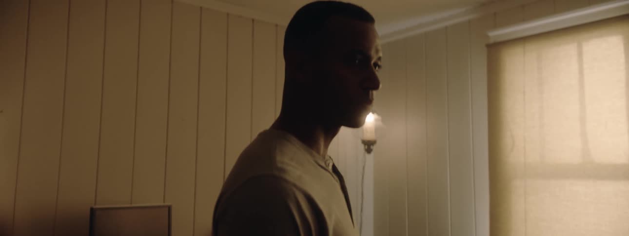 Man walks into dim room then turns around