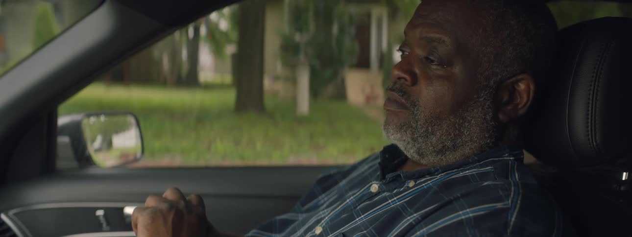 Elderly man sits in car