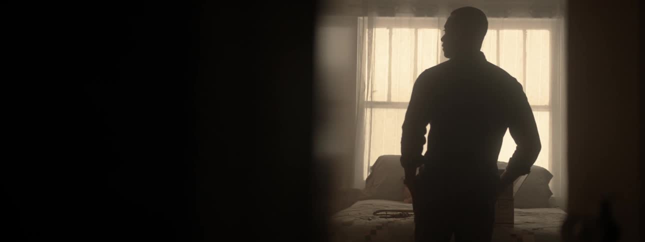 A man stands in a room looking around