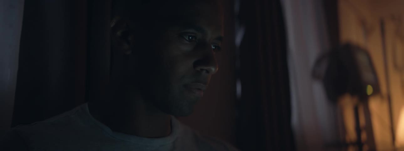 A man is looking at a piece of paper indoors