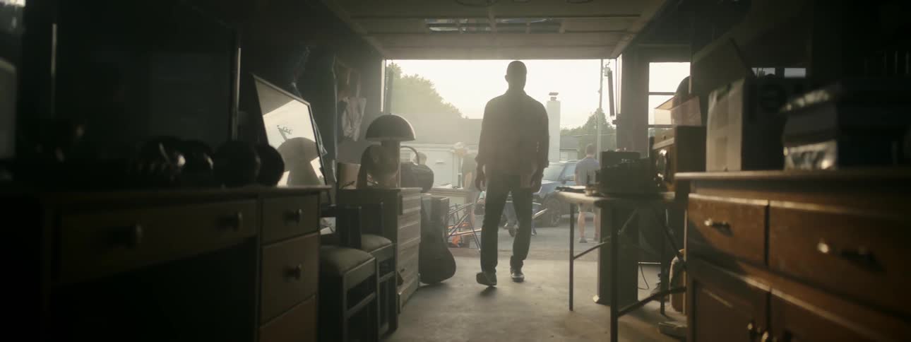 Man walks into open garage at garage sale