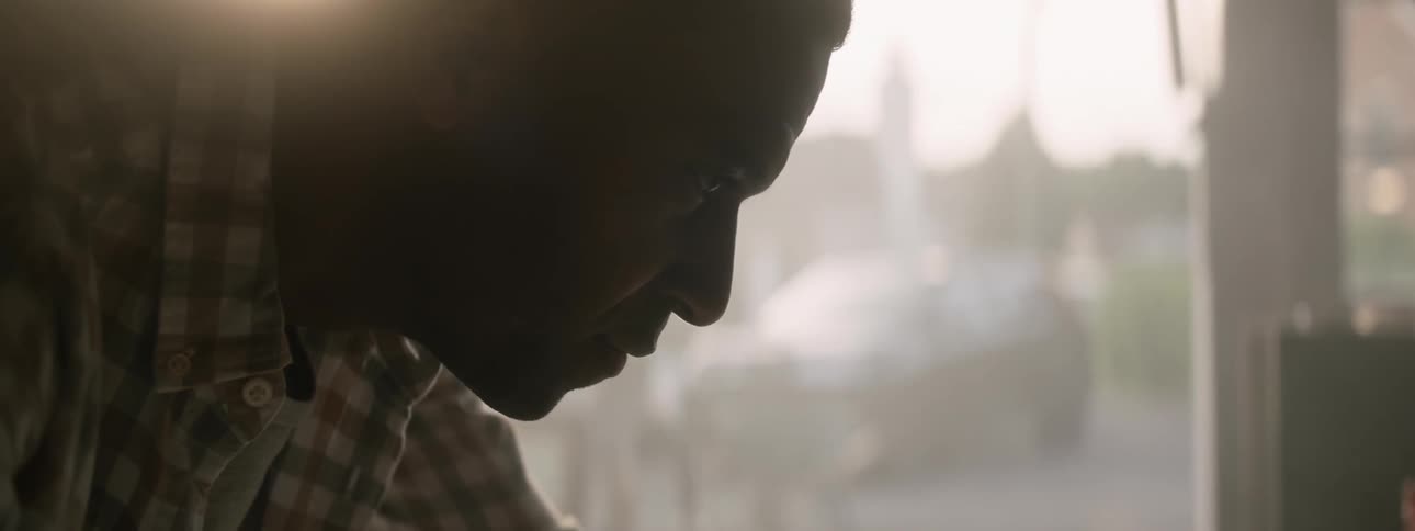 Man looks intently at an object off screen