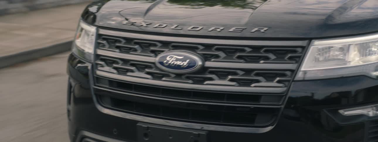 A ford explorer drives in suburban streets