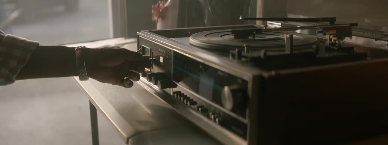 Person adjusts record player