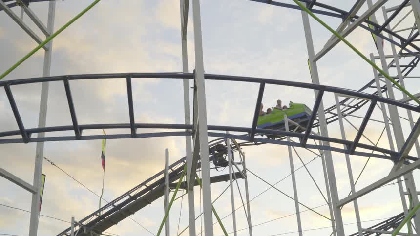 People riding in a roller coaster car