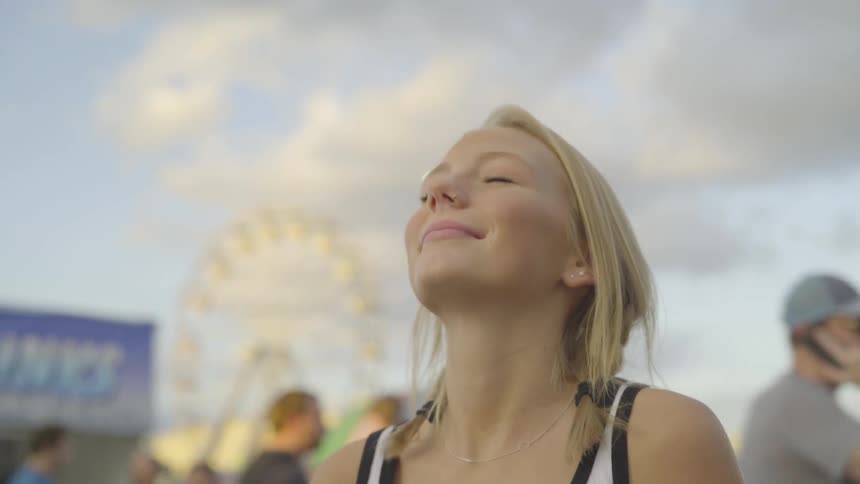 Girl looks up towards the sky and smiles