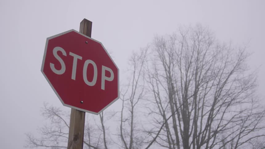 Stop sign on a wooden post