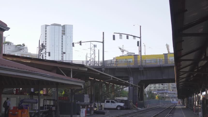 A trolley riding on an overpass in a city