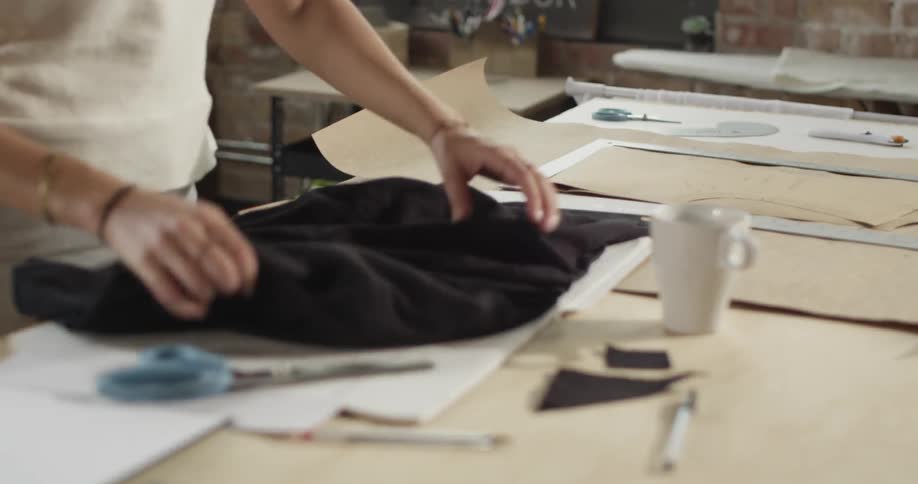 Seamstress cutting a piece of fabric