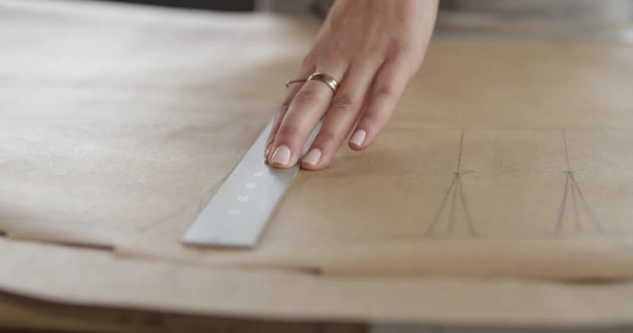 Person sketching on leather