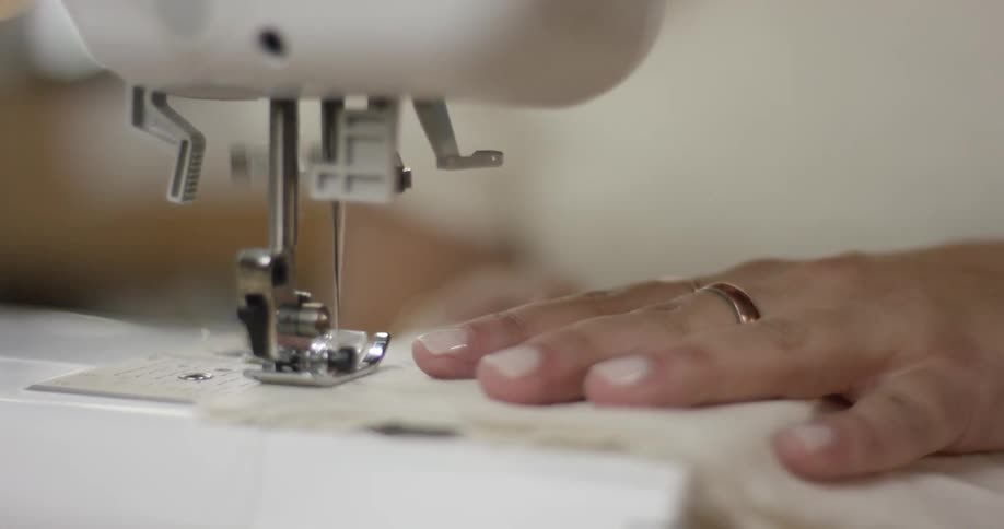 A person using a sewing machine