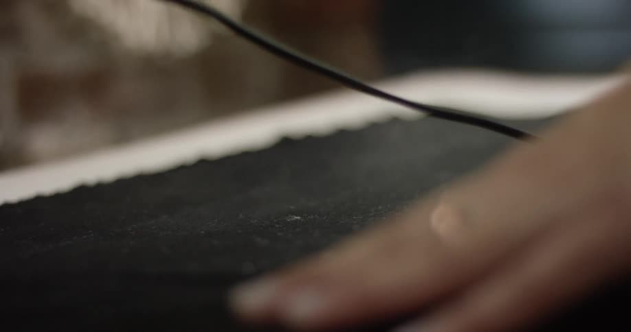 A person uses a steaming clothes iron