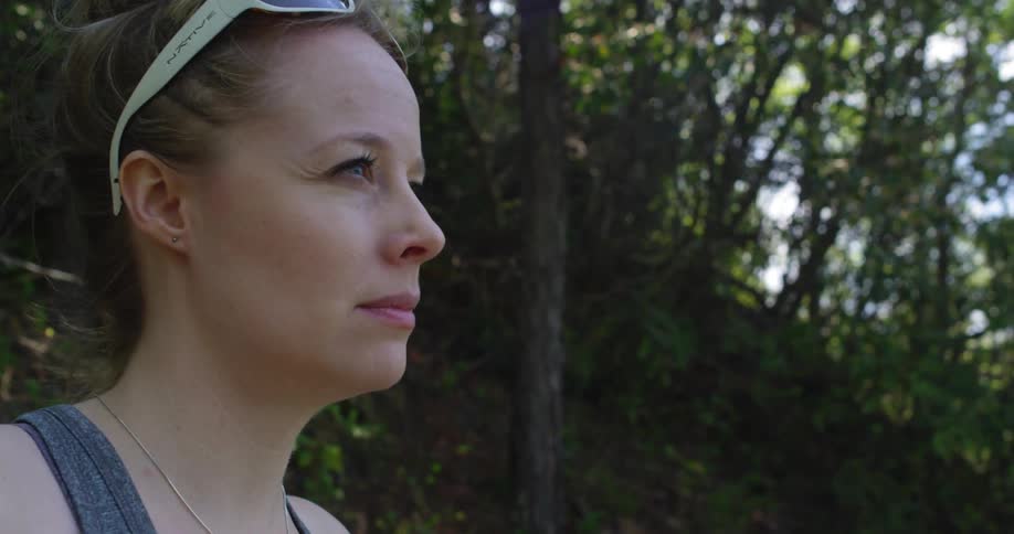 Woman Hiking Through Woods