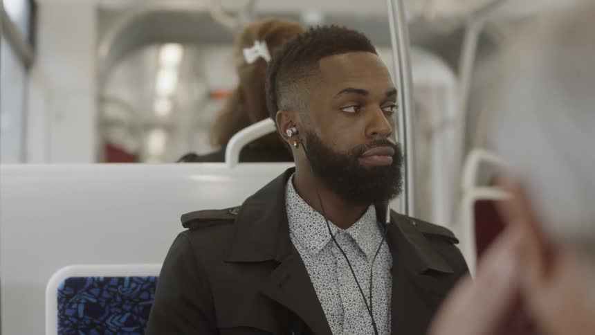 A man listening to music on the bus