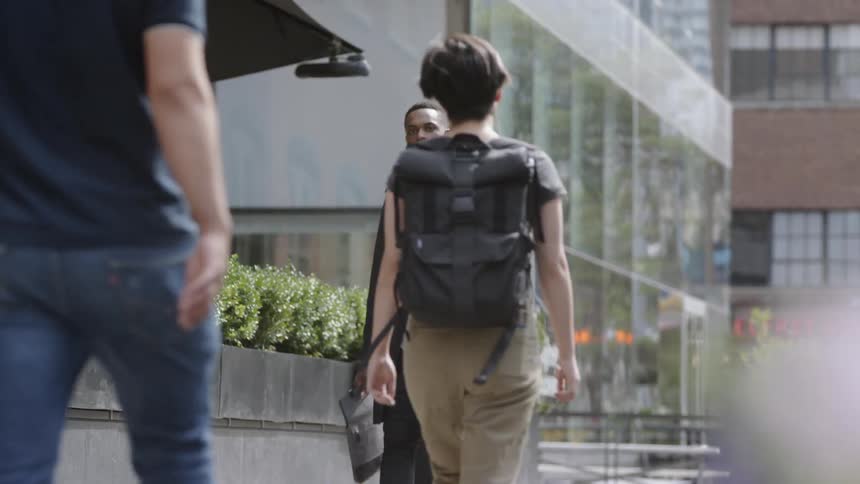 A man walking down the street with a bag