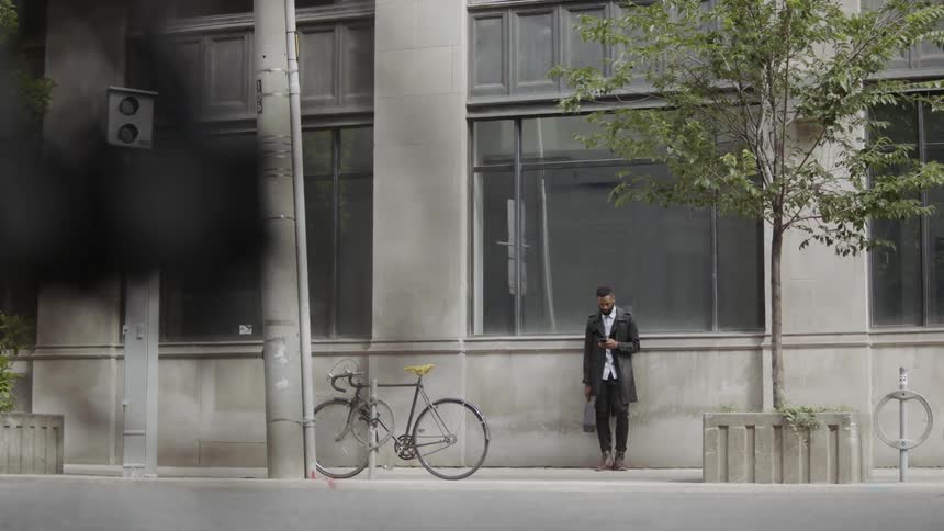 Man sitting against the wall downtown