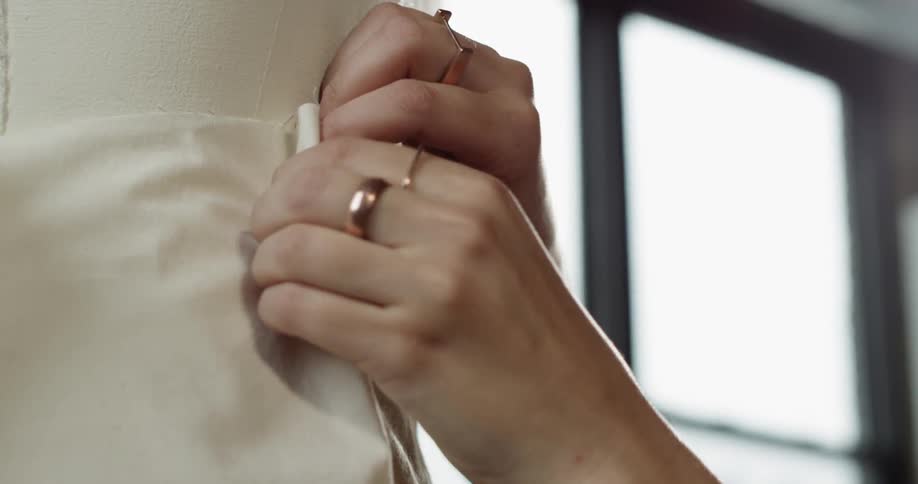 Two hands pinning fabric