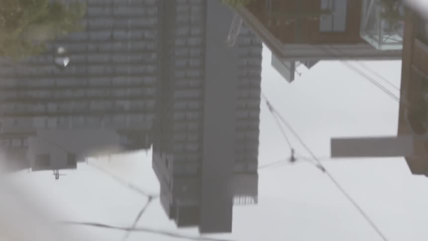 City buildings viewed from a puddle on the ground