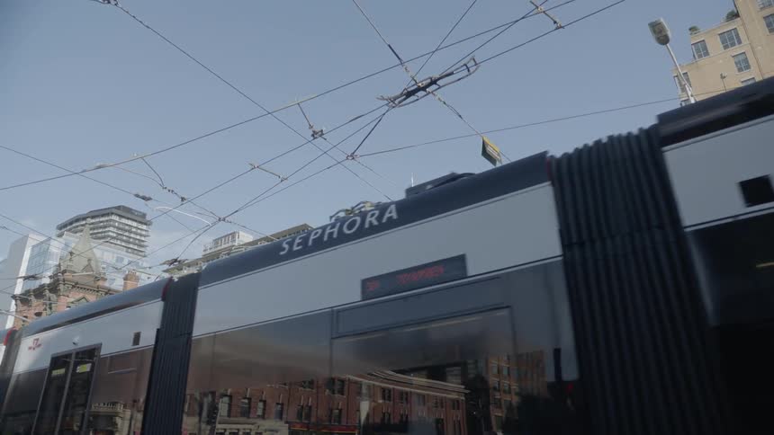 A commuter train passes through a city