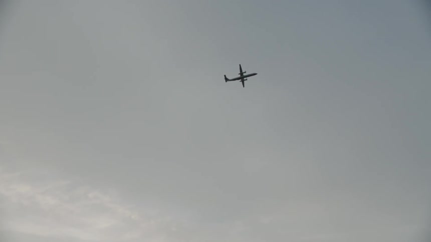 An airplane is flying in the sky