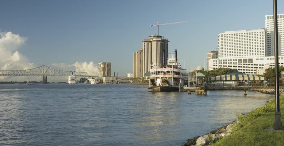 A ferry boat in the water by the pier