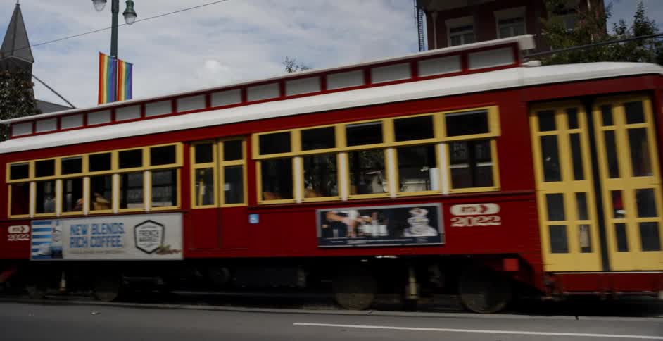 Red trolley car on city street