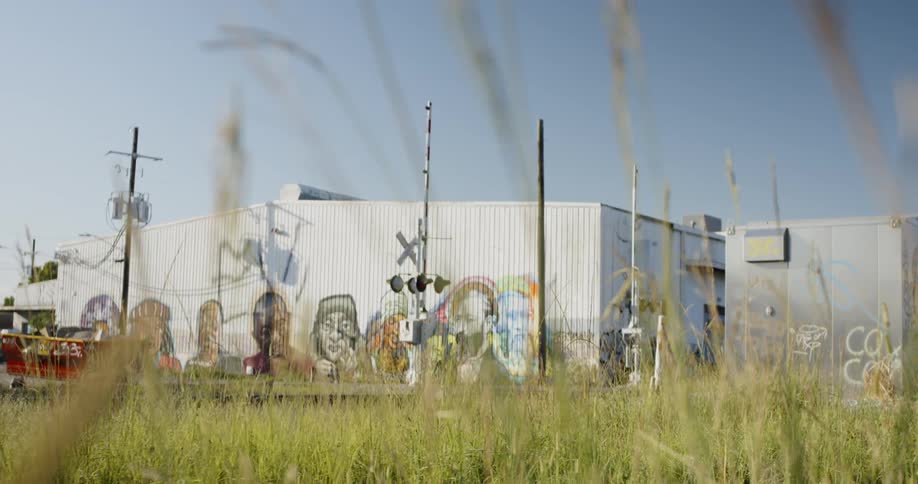 A metal building with murals of people on the outside
