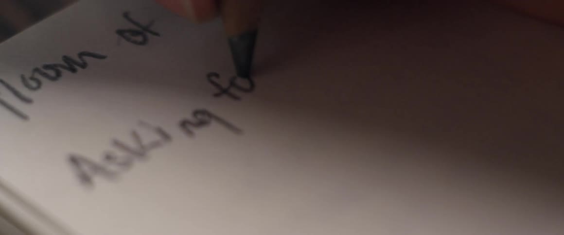 A person drawing with a pencil