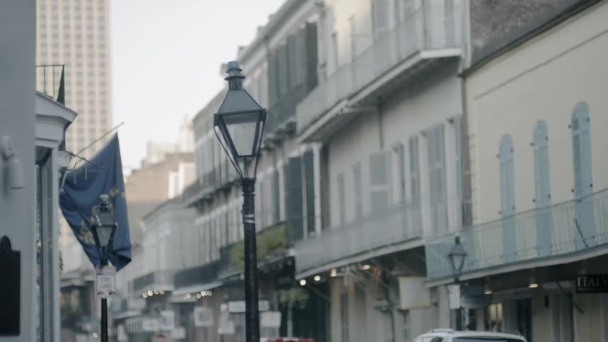 A tilted lamppost outside a building