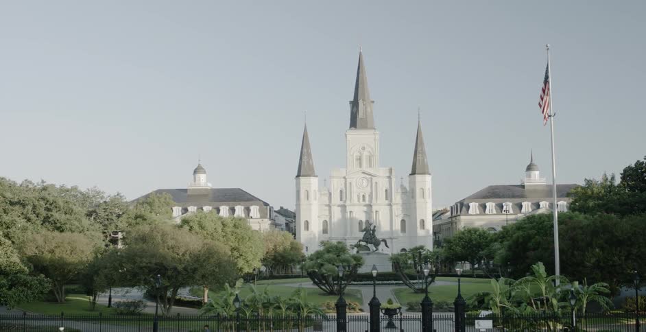 Cathedral with three steeples on a neatly landscaped lawn