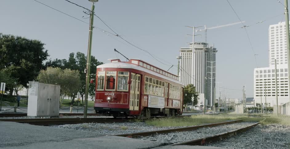Red trolley moves on track in city