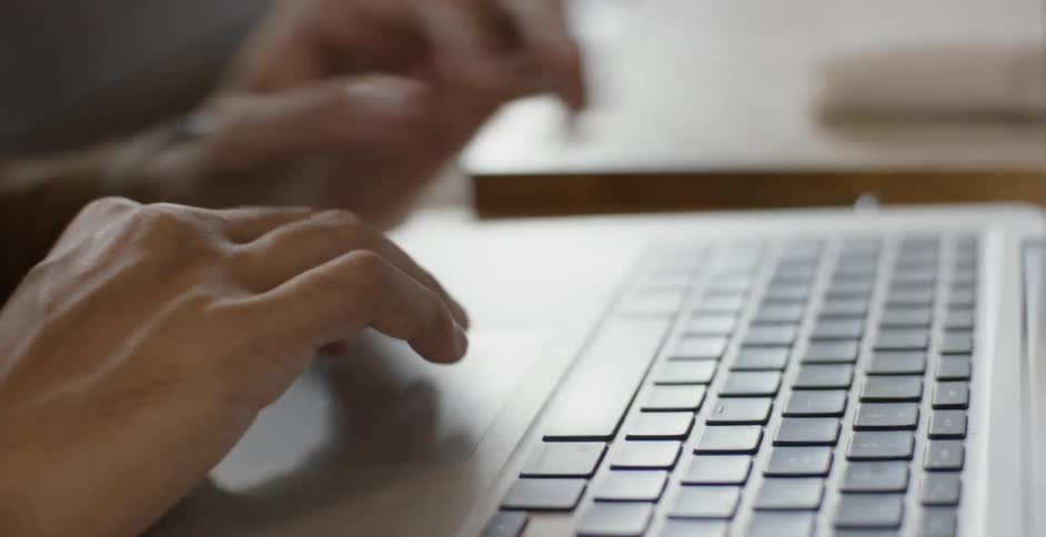 Person opens laptop and types