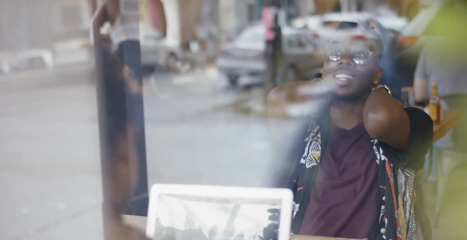 A man talks to someone in a restaurant