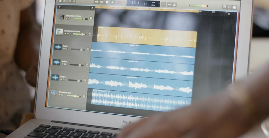 People showing audio tracks on a laptop screen