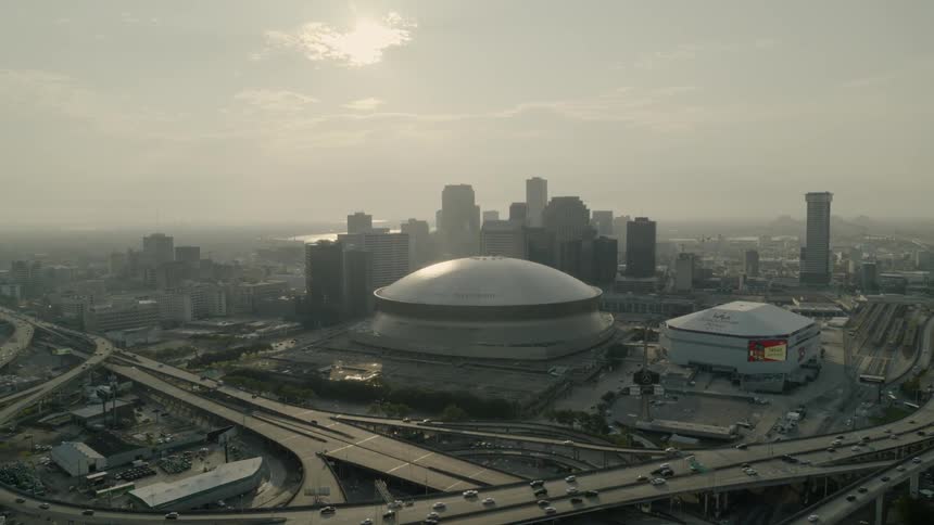 A sports arena surrounded by a city skyline and highways