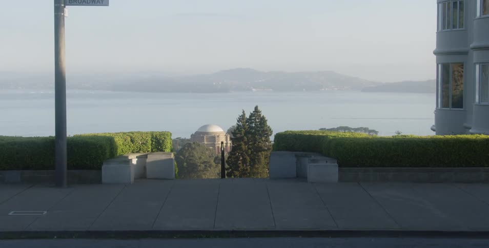 Landscape shot looking down at a building a lake and hills