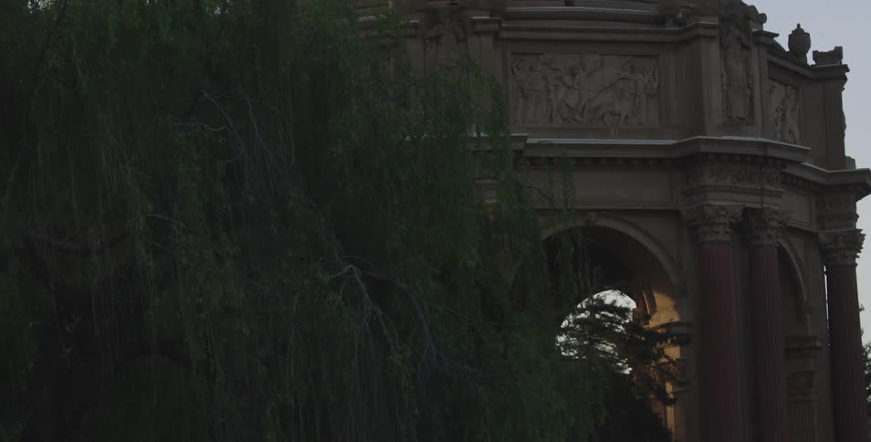Moving down a street to reveal an arch