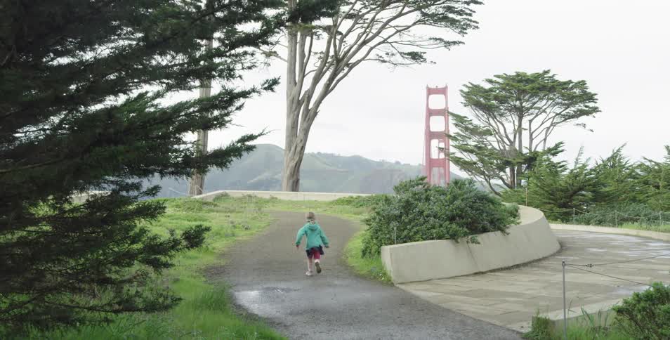 Child runs on path in park