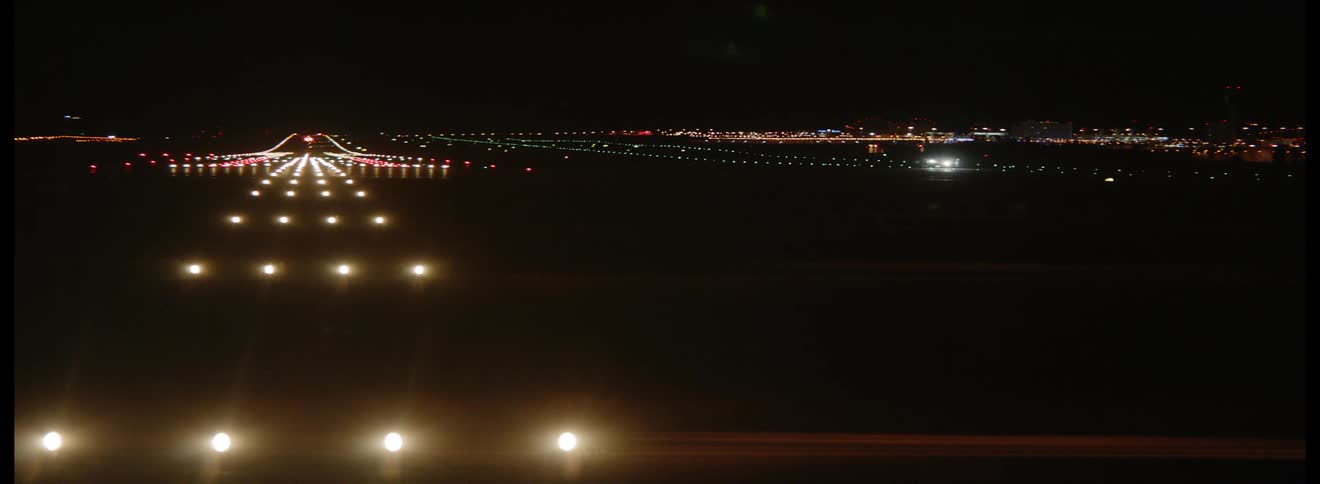 Lights illuminate an airport landing strip at night