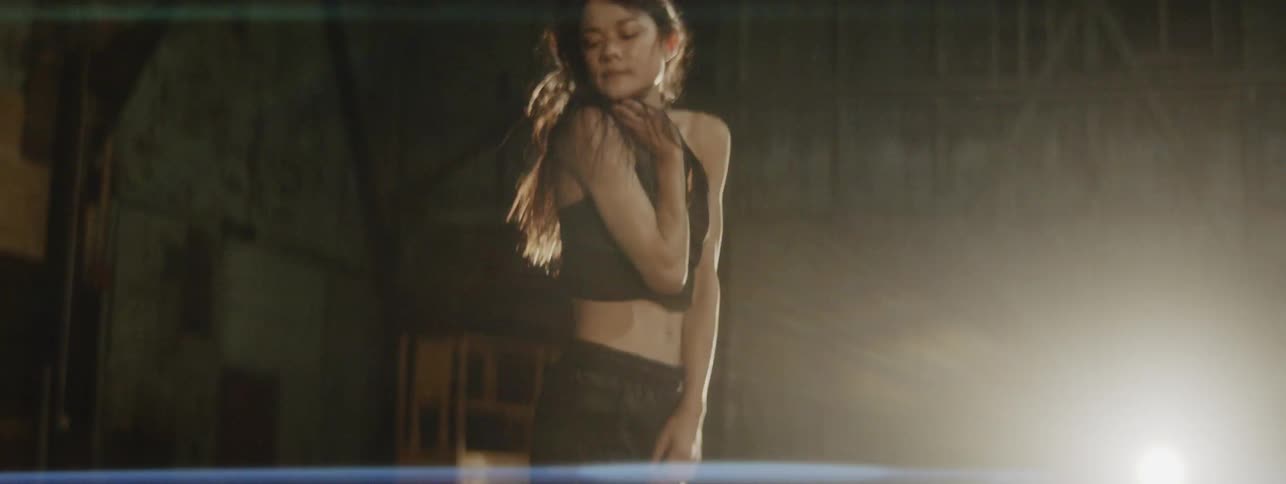 A woman dancing in an empty abandoned building