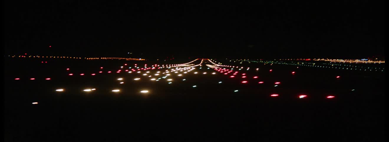 An airport runway at night with many lights